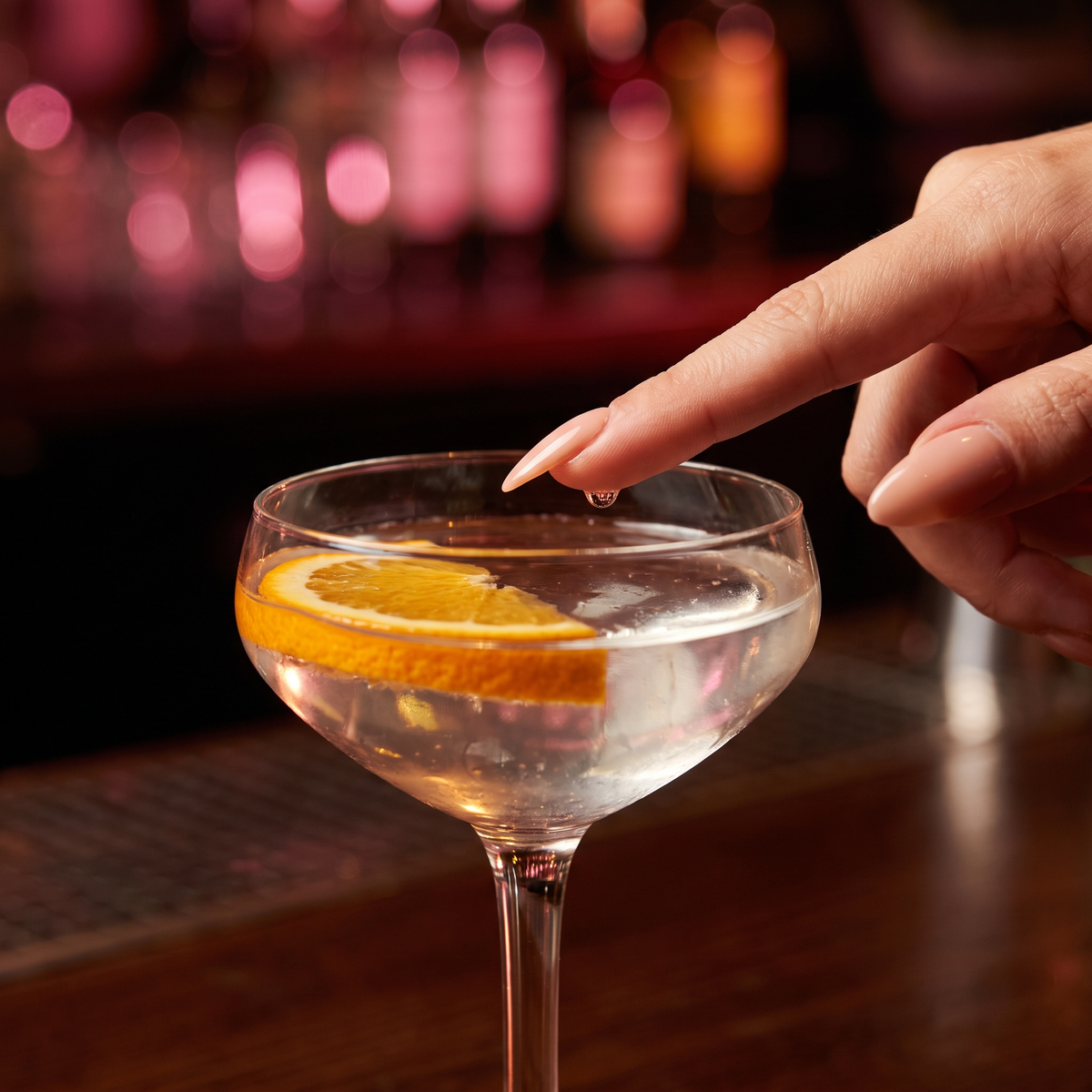 Touching a drop of the drink with a fingertip